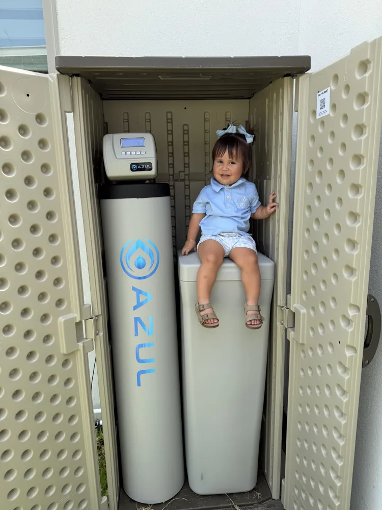 Enrique's daughter next to an Azul system, the reason we build clean water systems in Laredo
